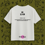 White t-shirt with 'Be Kind' text on a green background with child-like drawings