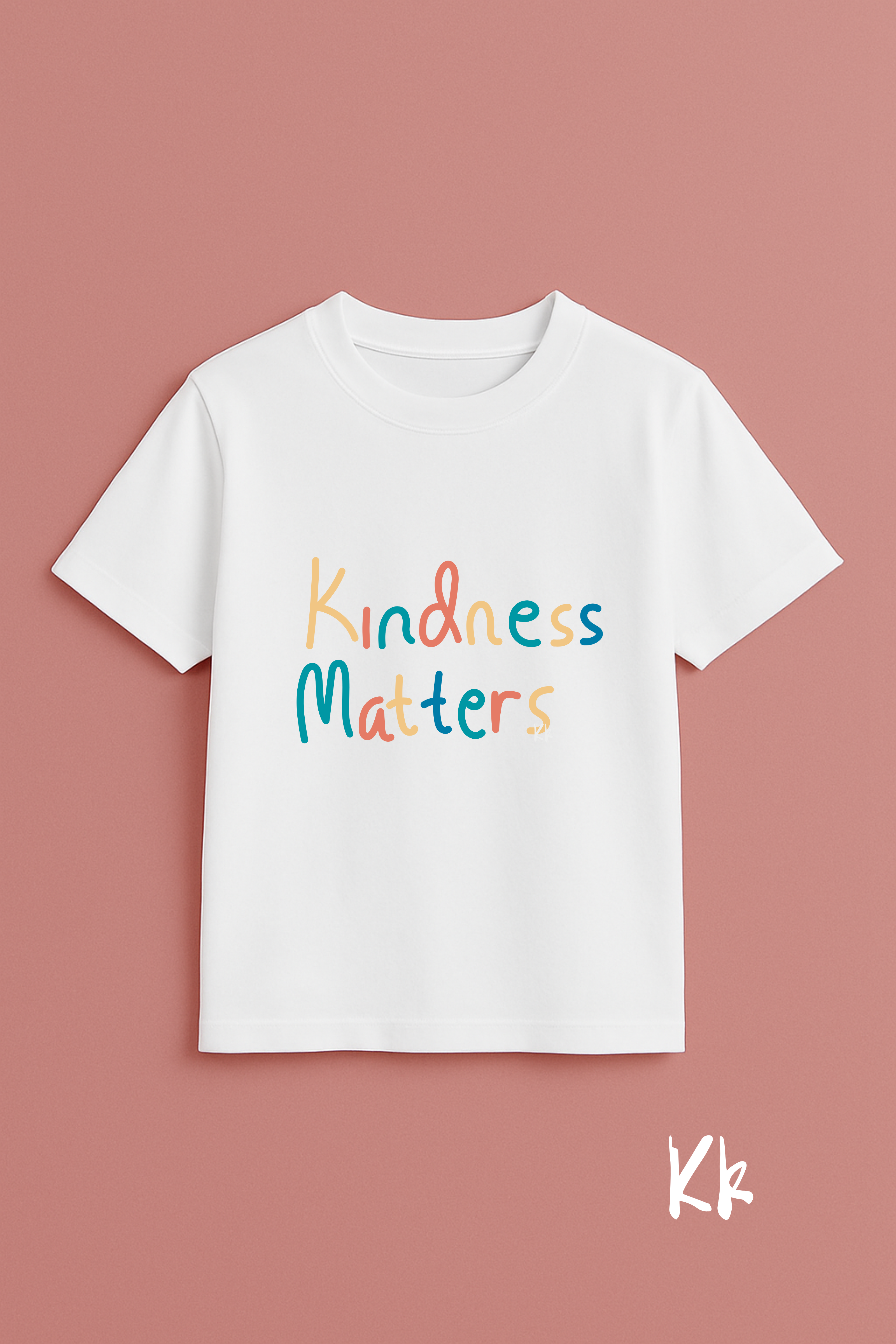 White t-shirt with 'Kindness Matters' text on a pink background
