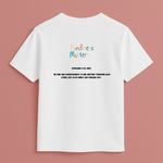 White t-shirt with 'Kindness Matters' text on a pink background