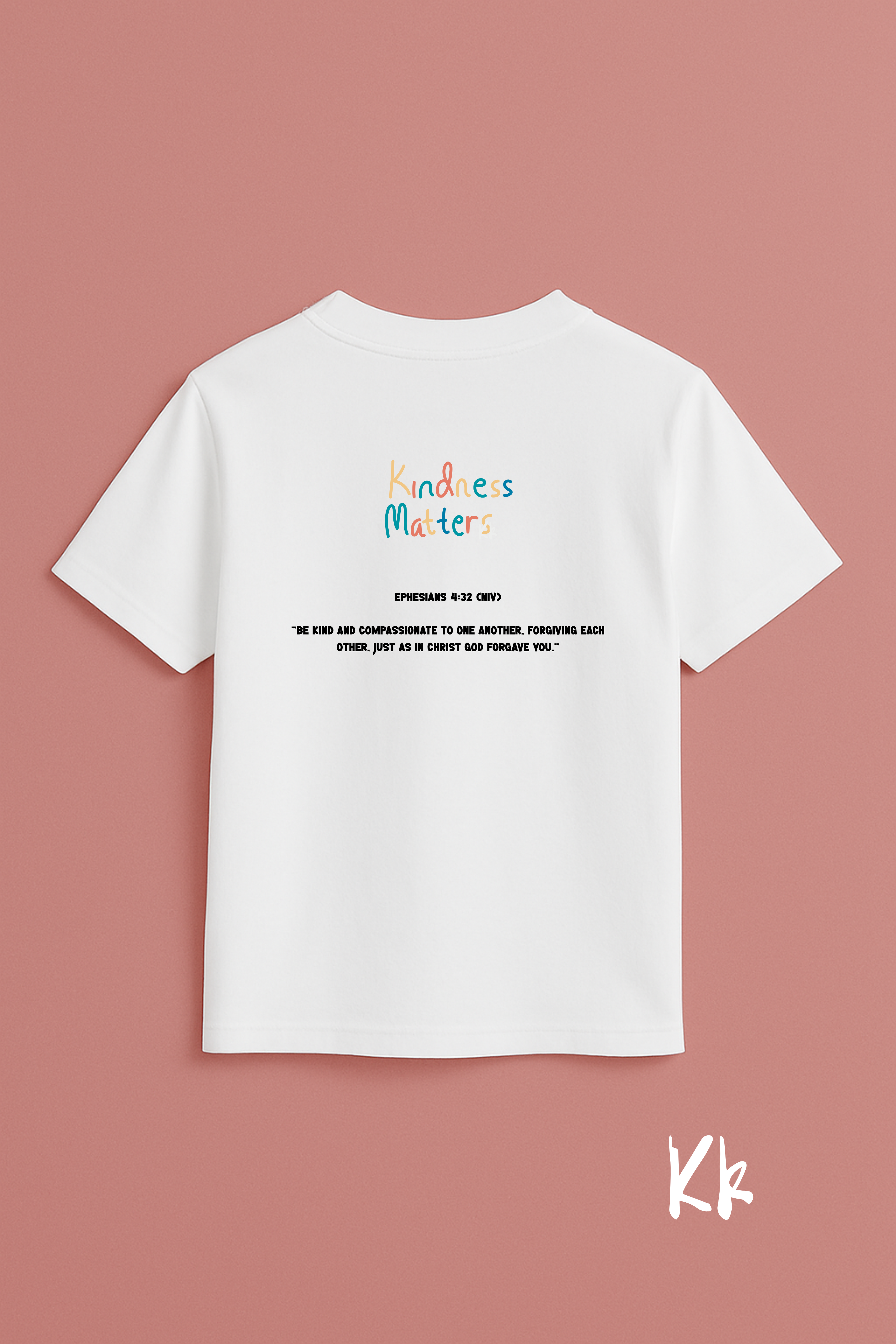 White t-shirt with 'Kindness Matters' text on a pink background