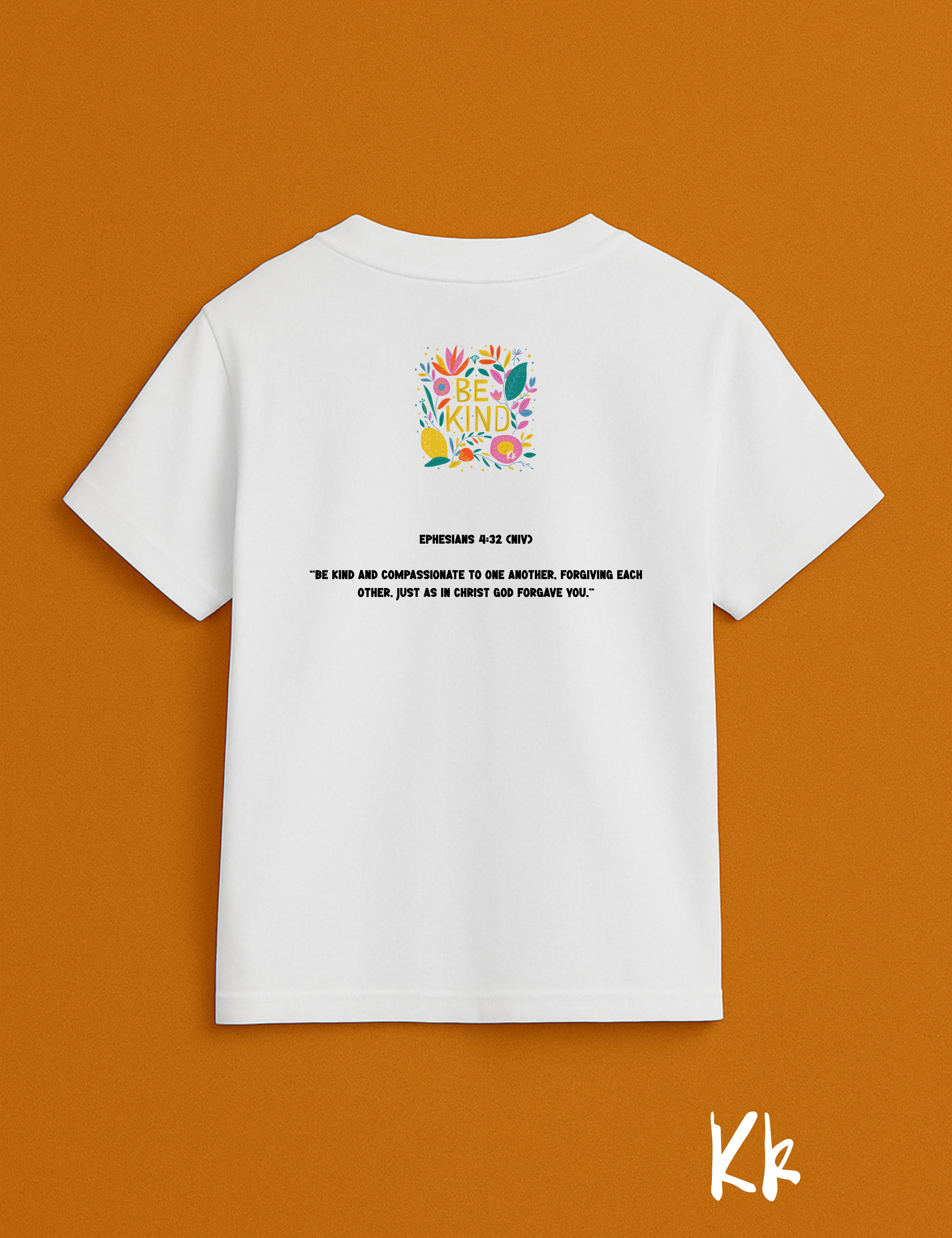 White t-shirt with colorful graphic and text on a brown background