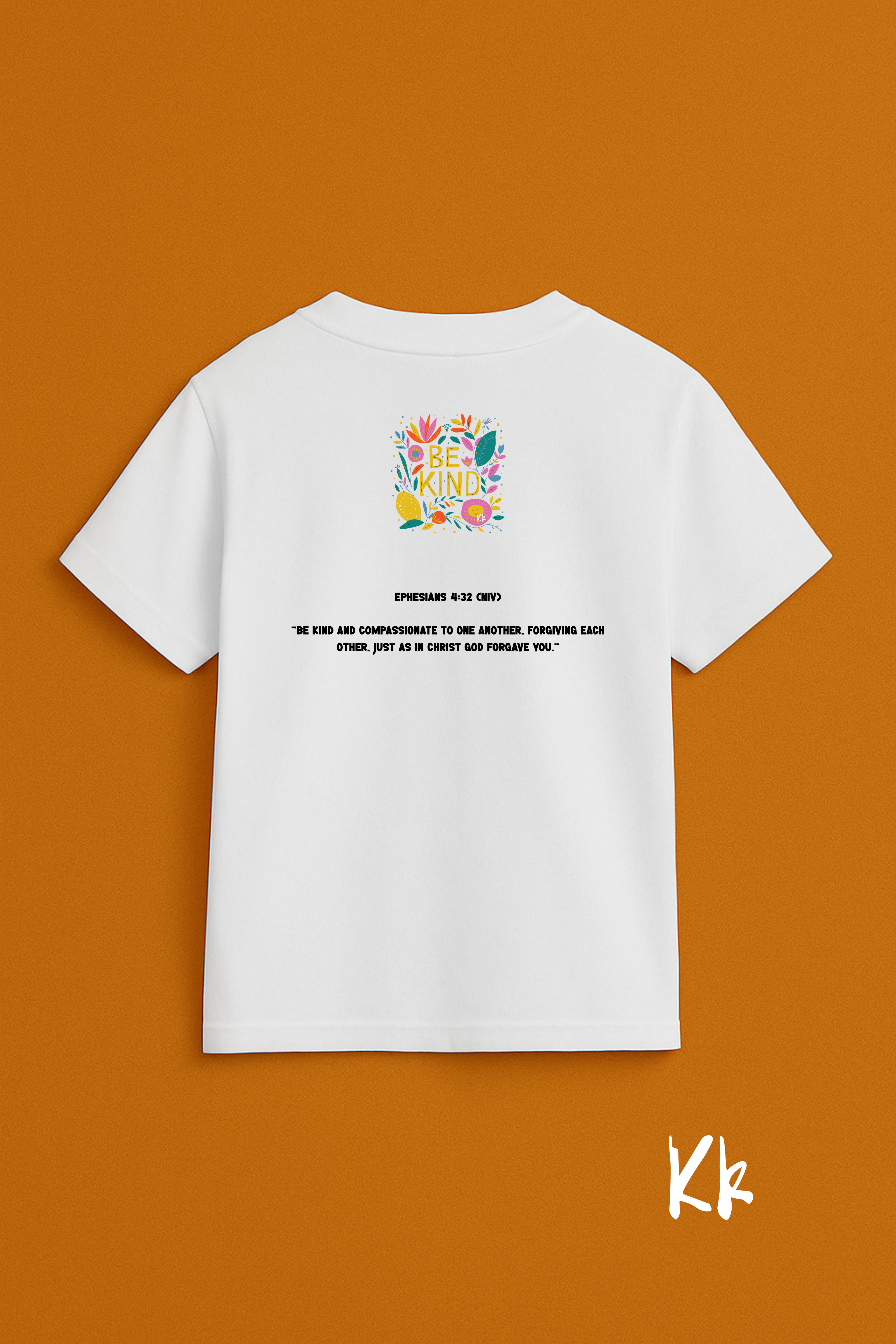 White t-shirt with colorful graphic and text on a brown background